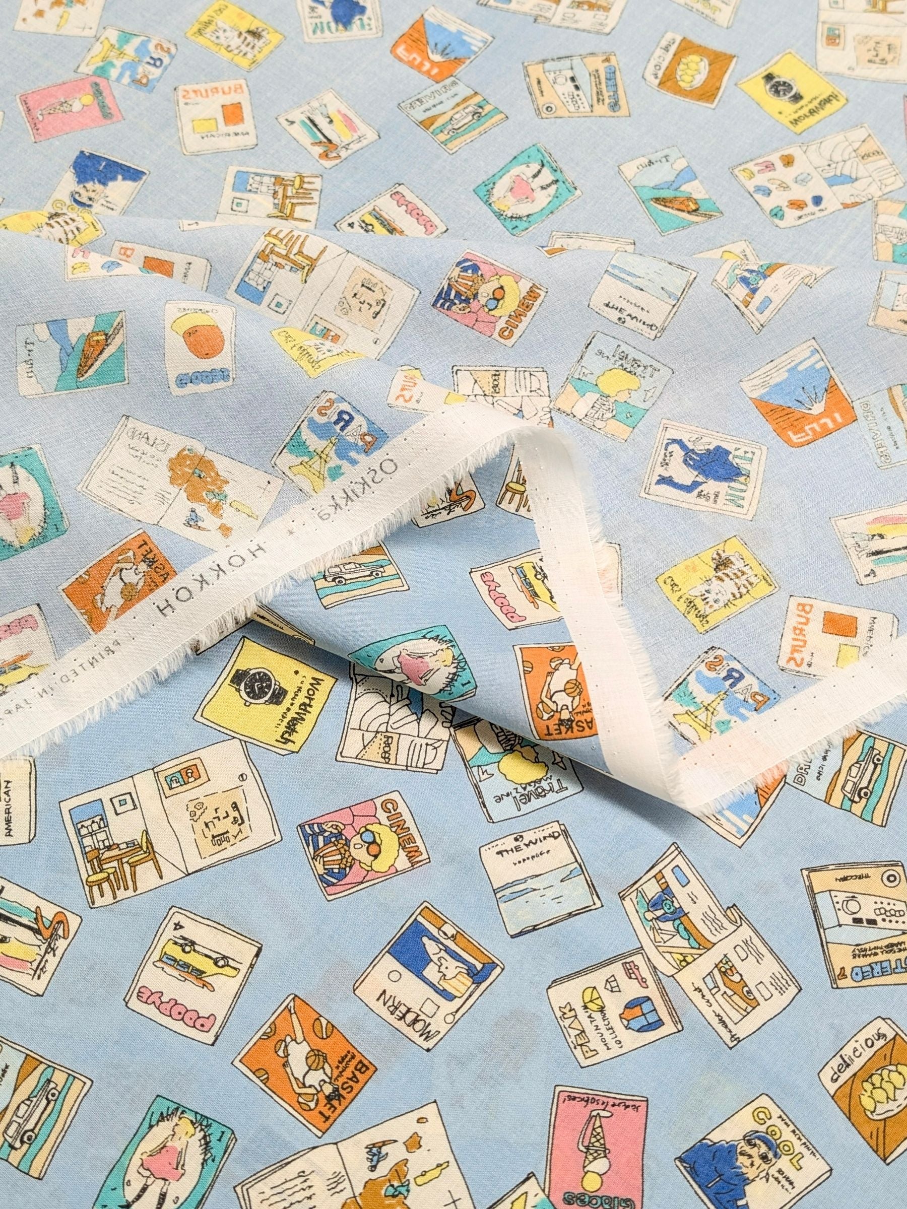 Hokkoh - Retro Magazines Cotton Lawn Fabric - Light Blue
